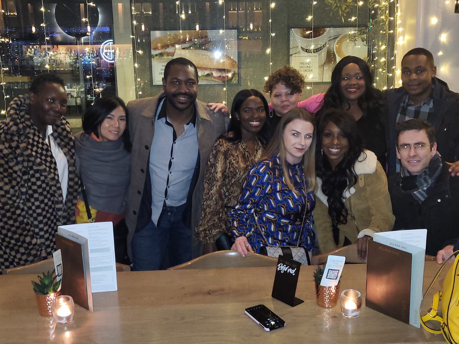 A group of diverse creatives posing together at an event, celebrating community and collaboration.